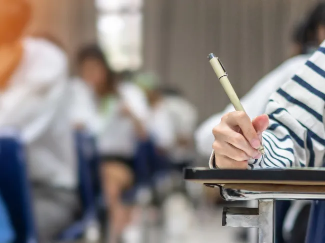 girl writing at desk